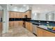 Kitchen with natural wood cabinets, black granite countertops, and stainless steel appliances at 3428 Longleaf Rd, Ormond Beach, FL 32174