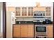 Compact kitchen with light wood cabinetry and stainless steel appliances, offering functionality in a small space at 3428 Longleaf Rd, Ormond Beach, FL 32174