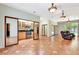 Open living room with tile flooring and kitchen access, blending living and culinary spaces at 3428 Longleaf Rd, Ormond Beach, FL 32174