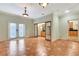 Bright living room with sliding doors, tile flooring, and views into the connected kitchen area at 3428 Longleaf Rd, Ormond Beach, FL 32174
