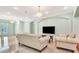 Bright living room with light-colored walls, tile floors, and elegant chandeliers at 3428 Longleaf Rd, Ormond Beach, FL 32174