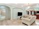 Spacious living room featuring tile floors, crystal chandelier, and views of the bathroom at 3428 Longleaf Rd, Ormond Beach, FL 32174