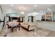 Spacious living room featuring tile floors, crystal chandelier, and views of the backyard at 3428 Longleaf Rd, Ormond Beach, FL 32174