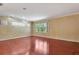Spacious living room featuring hardwood floors and large windows, providing natural light at 3428 Longleaf Rd, Ormond Beach, FL 32174