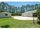 A well manicured, private yard with mature landscaping and tall trees in the distance at 3428 Longleaf Rd, Ormond Beach, FL 32174