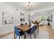 Modern dining room with table, chairs, chandelier, and view into the adjacent living area at 3655 Scott St, Port Orange, FL 32129