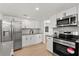 Modern kitchen with stainless appliances, light countertops and white cabinets at 3655 Scott St, Port Orange, FL 32129