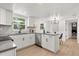 Newly renovated kitchen featuring stainless steel appliances, white cabinets, and breakfast bar at 3655 Scott St, Port Orange, FL 32129