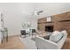 Bright living room featuring a brick fireplace, a neutral sofa, and modern decor at 3655 Scott St, Port Orange, FL 32129