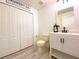 Bright bathroom with white vanity, tile floors, and convenient linen closet at 405 Carina Cir, Sanford, FL 32773