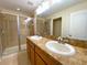 Bathroom featuring double sinks, vanity, shower and large mirror at 405 Carina Cir, Sanford, FL 32773