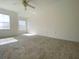 Bright bedroom with carpet flooring, ceiling fan and natural light from two windows at 405 Carina Cir, Sanford, FL 32773
