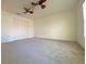 Bedroom featuring a ceiling fan, plush carpet, and a double door closet at 405 Carina Cir, Sanford, FL 32773