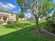 Beautifully landscaped community grounds featuring lush green grass, trees, and well-maintained buildings at 405 Carina Cir, Sanford, FL 32773