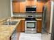 Well-equipped kitchen featuring stainless steel appliances, wood cabinets, and neutral countertops at 405 Carina Cir, Sanford, FL 32773