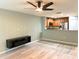 Living room area featuring modern shelf and an open view of the updated kitchen at 405 Carina Cir, Sanford, FL 32773