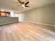 Open-concept living room with updated flooring and a view into the adjacent kitchen area at 405 Carina Cir, Sanford, FL 32773