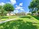 Well-maintained community with sidewalks, mature trees, and lush green lawns at 405 Carina Cir, Sanford, FL 32773