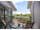 Inviting balcony with seating and views of lush greenery and neighborhood at 4403 Sea Mist Dr # 2110, New Smyrna Beach, FL 32169