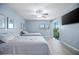 Bright bedroom featuring tile floors, a ceiling fan, flatscreen television, and a sliding door to a balcony at 4403 Sea Mist Dr # 2110, New Smyrna Beach, FL 32169