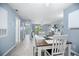 Dining room featuring tile floors, a ceiling fan, and a view of the living room and outdoor space at 4403 Sea Mist Dr # 2110, New Smyrna Beach, FL 32169