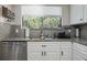 Well-lit kitchen featuring granite counters, modern appliances, tile backsplash, and a scenic window view at 4403 Sea Mist Dr # 2110, New Smyrna Beach, FL 32169