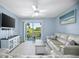 Open living room with sliding glass doors, a ceiling fan, tile floors, and comfortable seating at 4403 Sea Mist Dr # 2110, New Smyrna Beach, FL 32169