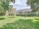 Expansive backyard with mature trees and a screened-in patio at 456 Sea Duck Dr, Daytona Beach, FL 32119
