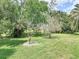 A lush green backyard with various trees offers shade and privacy at 456 Sea Duck Dr, Daytona Beach, FL 32119