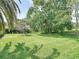 Large backyard with mature trees providing ample shade and privacy at 456 Sea Duck Dr, Daytona Beach, FL 32119