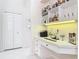 Bar area with shelving for glassware and liquor bottles, plus desk area with drawers at 456 Sea Duck Dr, Daytona Beach, FL 32119