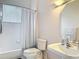 Clean bathroom with a shower-tub combo, pedestal sink, and neutral color scheme at 456 Sea Duck Dr, Daytona Beach, FL 32119