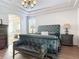 Spacious bedroom boasts a tray ceiling, elegant decor, and a luxurious leather bench at 456 Sea Duck Dr, Daytona Beach, FL 32119