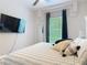 Bedroom featuring a neutral color palette and minimalist decor with an accent wall and ceiling fan at 456 Sea Duck Dr, Daytona Beach, FL 32119
