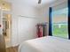 Bedroom boasts large window, closet, and bright hallway, offering ample space and storage at 456 Sea Duck Dr, Daytona Beach, FL 32119
