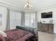 Lovely bedroom features a large window, seating area, and dresser with TV, for comfortable living at 456 Sea Duck Dr, Daytona Beach, FL 32119