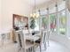 Bright dining room with chandelier, large windows, and modern furniture, perfect for entertaining guests at 456 Sea Duck Dr, Daytona Beach, FL 32119