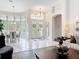 Elegant entryway with chandelier, decorative wreaths on doors, and view into dining area at 456 Sea Duck Dr, Daytona Beach, FL 32119