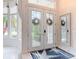 Inviting entryway with stained glass double doors, ceramic tiled floors, and natural light at 456 Sea Duck Dr, Daytona Beach, FL 32119