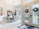 Elegant entryway with decorative glass doors, tiled floor, and dining area with ample natural light at 456 Sea Duck Dr, Daytona Beach, FL 32119
