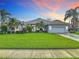 Charming single-story home with well-manicured lawn and lush landscaping at 456 Sea Duck Dr, Daytona Beach, FL 32119