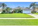 Lovely single-story home with lush landscaping and a green front lawn at 456 Sea Duck Dr, Daytona Beach, FL 32119