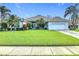 Charming single-story home with a well-manicured lawn and tropical landscaping, perfect for Florida living at 456 Sea Duck Dr, Daytona Beach, FL 32119
