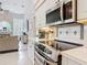 Well-lit kitchen with sleek appliances, white cabinets, and view into living area at 456 Sea Duck Dr, Daytona Beach, FL 32119