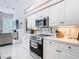 Modern kitchen featuring white cabinets and countertops and stainless steel appliances at 456 Sea Duck Dr, Daytona Beach, FL 32119