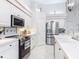 Bright kitchen with white cabinetry, stainless steel appliances, and tiled flooring at 456 Sea Duck Dr, Daytona Beach, FL 32119