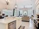 Open-concept kitchen showing island with sink, white cabinets, and tiled flooring at 456 Sea Duck Dr, Daytona Beach, FL 32119