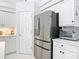 Bright kitchen features stainless steel refrigerator, white cabinets, and under cabinet lighting at 456 Sea Duck Dr, Daytona Beach, FL 32119