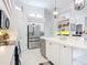 Bright kitchen with white cabinetry, stainless steel appliances, and tiled flooring at 456 Sea Duck Dr, Daytona Beach, FL 32119