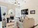 Cozy living room with a fireplace, ceiling fan, plush seating and large arched window at 456 Sea Duck Dr, Daytona Beach, FL 32119